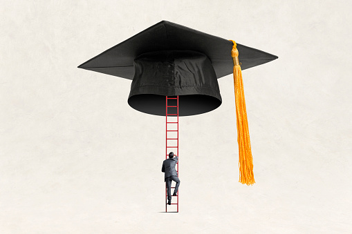 A man uses a ladder to scale the heights of a college education illustrated by a graduation cap and tassel.