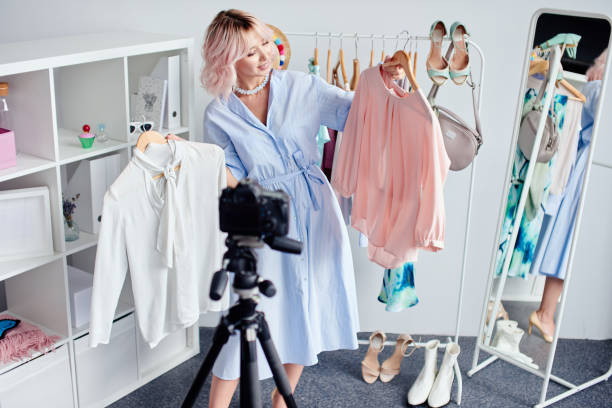 istock Woman selecting summer outfit, recording vlog 2034447741