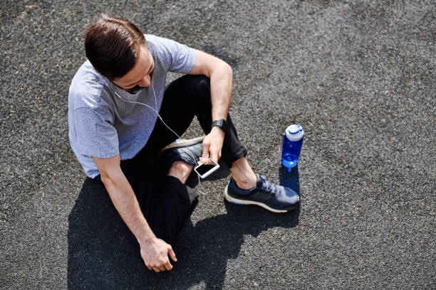istock Sportive young man using smart phone for workout 2034451258