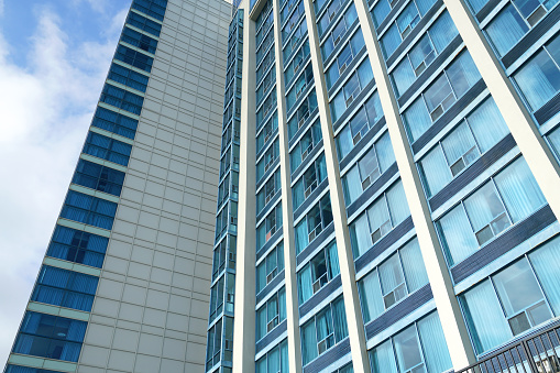 low angle view of modern office building skyscraper with blue glass wall