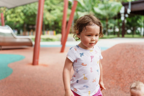 istock Little girl having fun at the park 2034469680