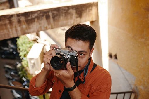 Vietnamese photographer taking pictures on abandoned building