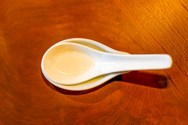 Three ceramic spoons were placed on a Japanese-style mat.
