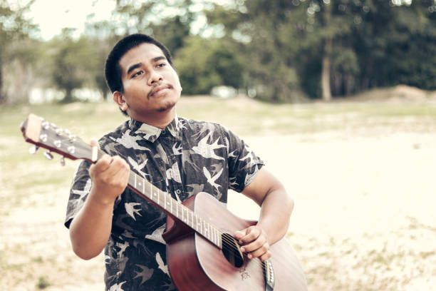 istock male brown guitarist 2034560011