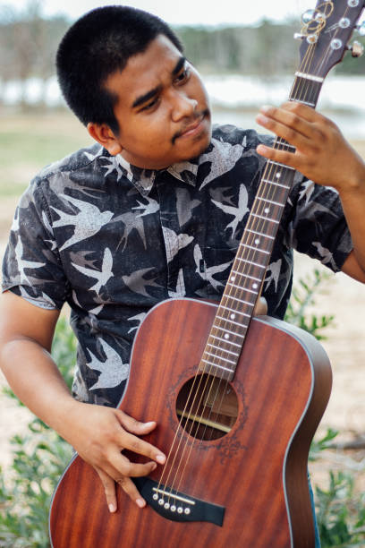 male brown guitarist