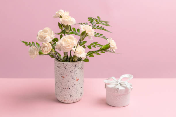 istock Bouquet of carnations in a vase with a gift box. 2034576847