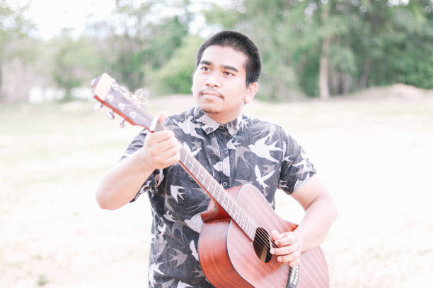 istock male brown guitarist 2034618974