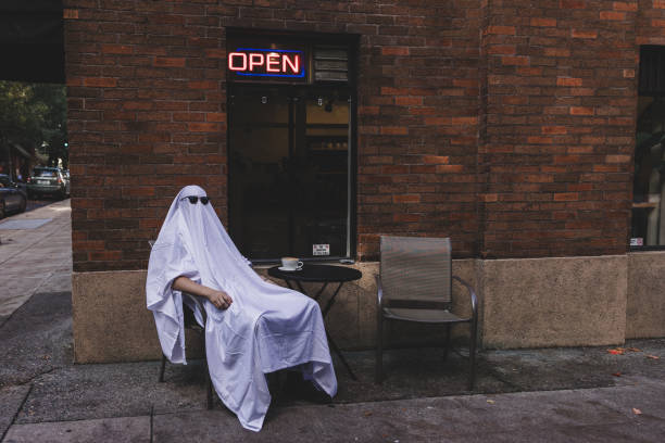 istock Spooky Halloween Ghost Outside of Old Brick Building 2034631190