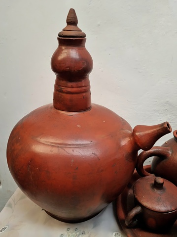 Bandung, Indonesia - Feb 24, 2024: Picture of one set traditional Javanese clay pottery for drinking used as decoration