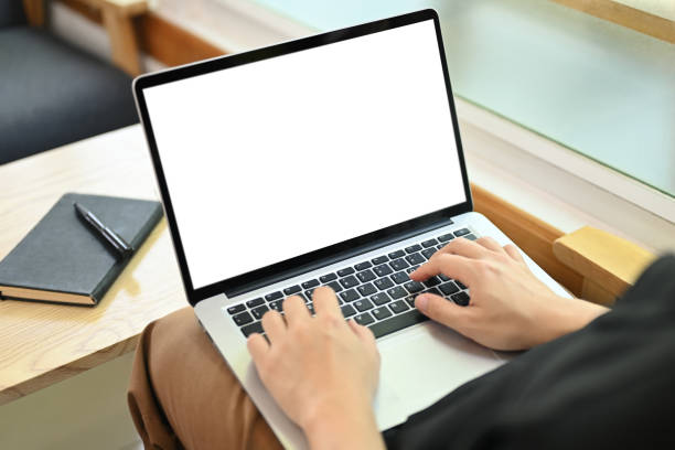 istock Man freelancer using laptop on wooden table at coffee shop. Close up view 2034668963