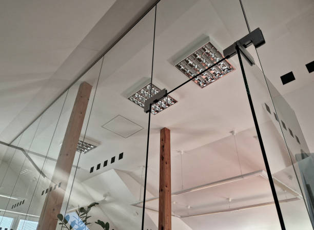 the attic room with plasterboard ceiling is supported by pine wood beams. rustic style with a glass partition, light