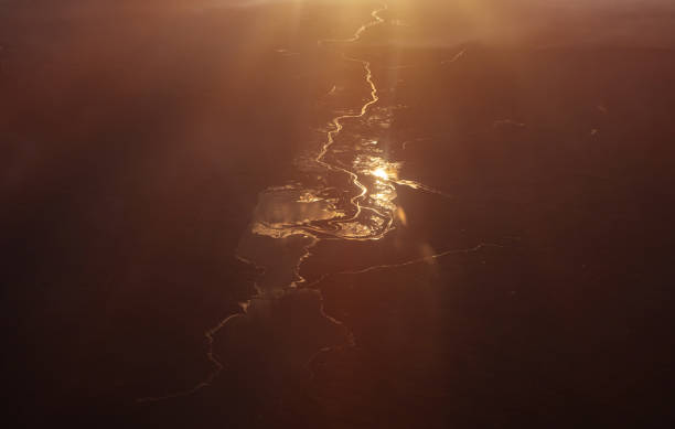 Winding river at sunset, seen from airplane.