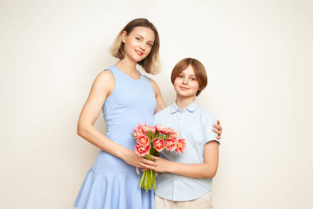 istock Boy gives his mother flowers 2034743908