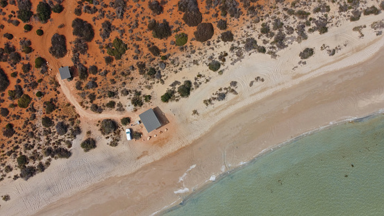 Drone photo of the ocean meeting the desert at Little Lagoon near Denham in Western Australia, which is the westernmost publicly accessible town in Australia. It is located in the Shark Bay World Heritage Site in the Gascoyne region