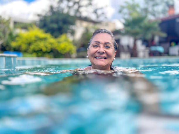 istock Senior Hispanic woman in swimming pool 2034771240