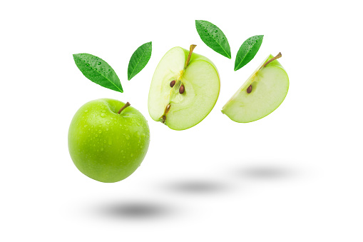 Flying green apple with slices and green leaf isolated on white background.