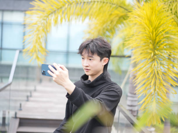 istock Asian man taking selfie with smartphone 2034799083