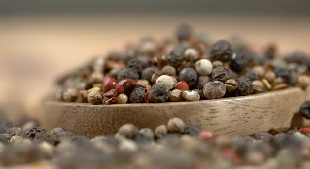 Mixed peppercorns in a super slow motion. Dry mix peppercorns close up.
