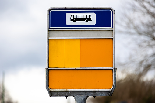 A selective focus image of a no entry road sign against a blurred building.