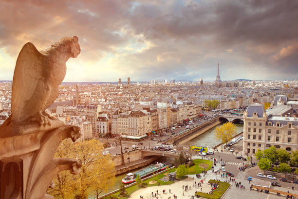 Le Stryge Chimera sculpture on Notre Dame cathedral  overlooks Paris with the river Seine and Eiffel tower