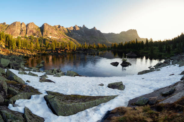 istock Mountain clear glacier lake among large rocks and cedar forest. 2034823870