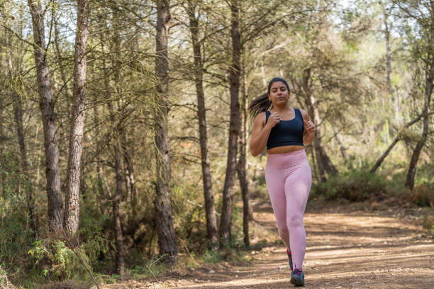 istock Woman running in forest 2034850284