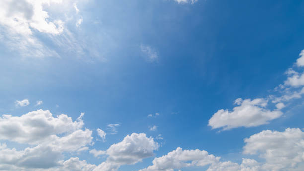istock Panoramic view of clear blue sky and clouds, Blue sky background with tiny clouds. White fluffy clouds in the blue sky. Captivating stock photo featuring the mesmerizing beauty of the sky and clouds. 2034852375