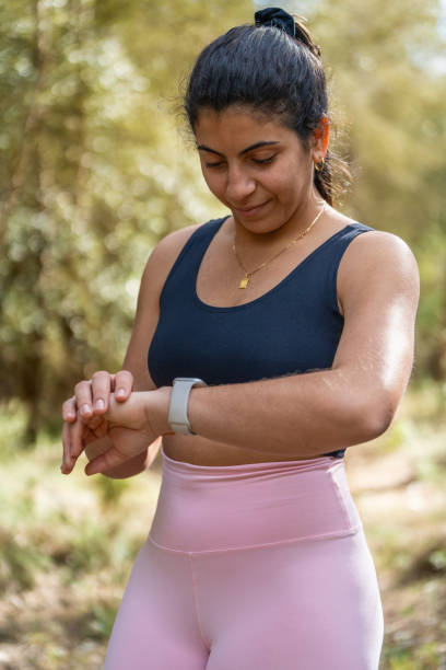 istock Woman checking smartwatch in the forest 2034852381