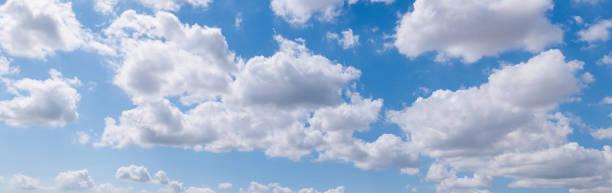 istock Panoramic view of clear blue sky and clouds, Blue sky background with tiny clouds. White fluffy clouds in the blue sky. Captivating stock photo featuring the mesmerizing beauty of the sky and clouds. 2034858211