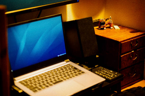 Desk and laptop in small house.