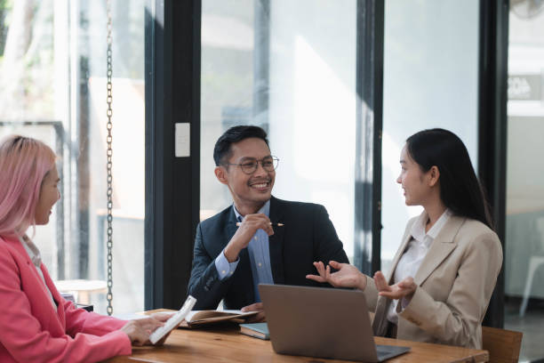 istock Energetic Asian Business Professionals Collaborate in Dynamic Ideation Session. 2034874427