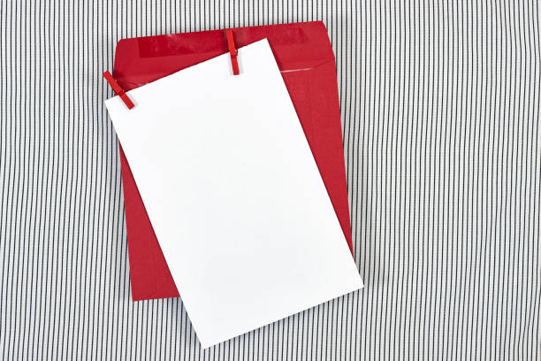 Blank greeting card, flyer or invitation card mockup with red peg, envelope on lines background