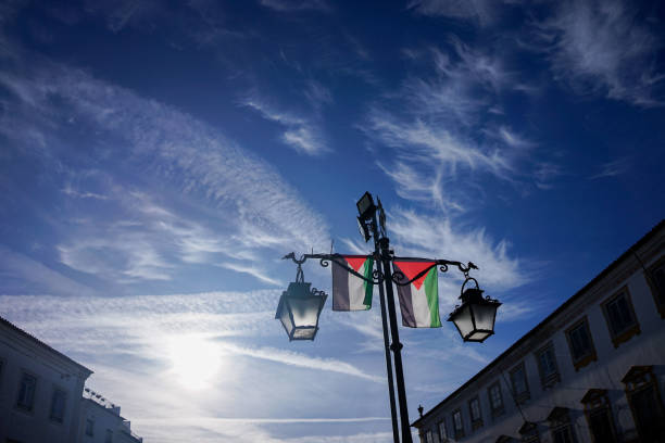 Évora, Alentejo, Portugal. February 18, 2024. Palestinian flags hanging on lampposts at Geraldo Square in Évora, creating a vibrant and supportive scene—a reflection of global solidarity.
