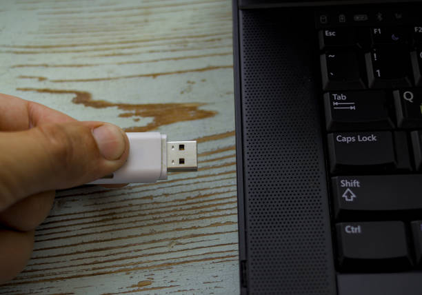 istock Hand connecting usb flash drive to laptop 2034917043