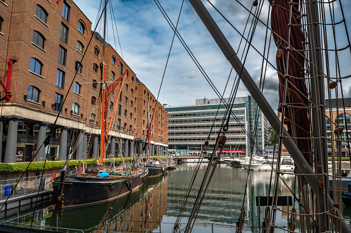 Boats And Ships In St Katharine Docks With Office Buildings And Restaurants In London, United Kingdom