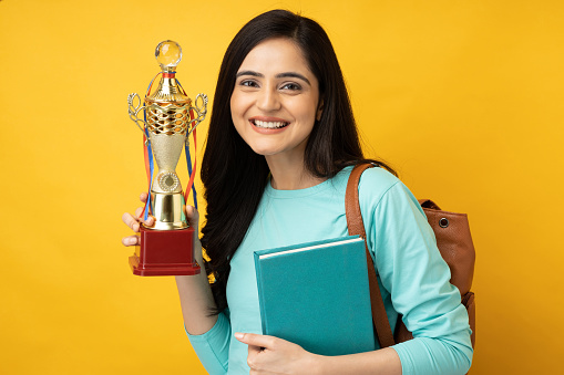 Portrait of college student on yellow background