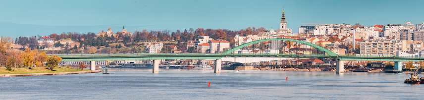 Belgrade's iconic bridge spans the Danube, offering a picturesque view of the city's historical skyline against a backdrop of clear blue skies.