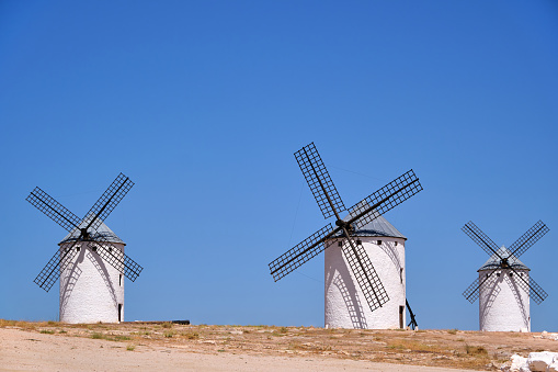 The famous windmills that inspired the giants of Don Quixote of La Mancha. Photograph with the blue and clear sky in summer.