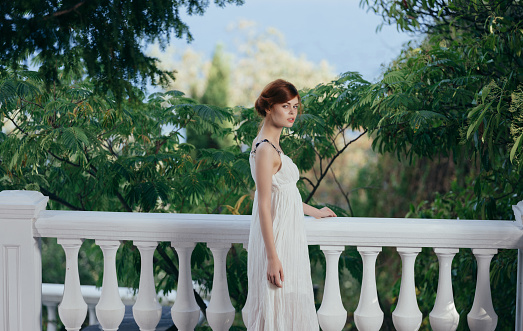 Pretty woman in white dress Greek style mythology nature. High quality photo