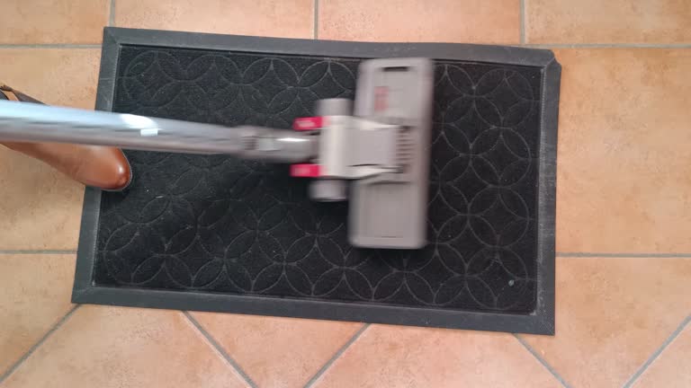 close-up of a vacuum cleaner's broom cleaning a doormat