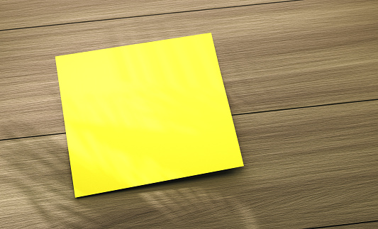 Empty post it paper on wood table