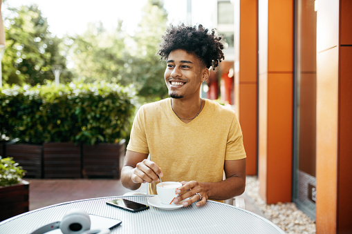 African American student in the city, taking a coffee break