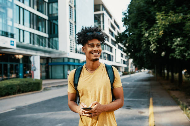 istock Multiracial young man in the city, using smart phone 2034990684