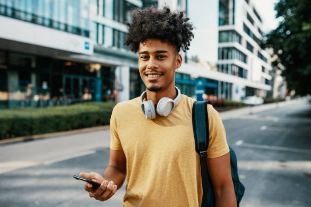 istock Multiracial young man in the city, using smart phone 2034992245