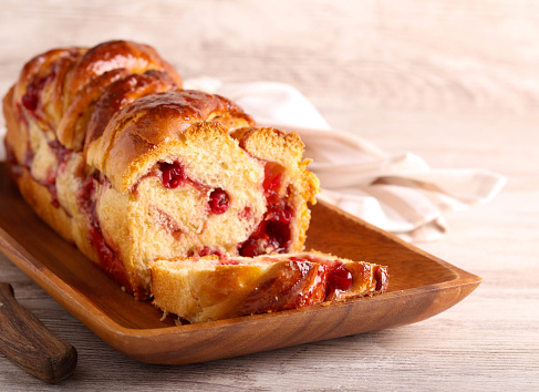 Redcurrant and white chocolate babka bread, on wooden plate