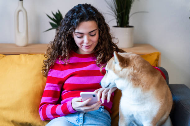 istock Woman and Dog Enjoying Couch Time 2035030780