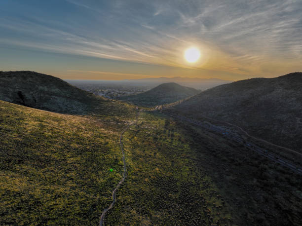 istock Scenic view of sunset over green hills 2035045609