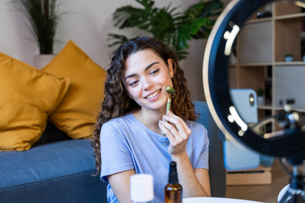 Smiling Woman with Facial Massage Tool