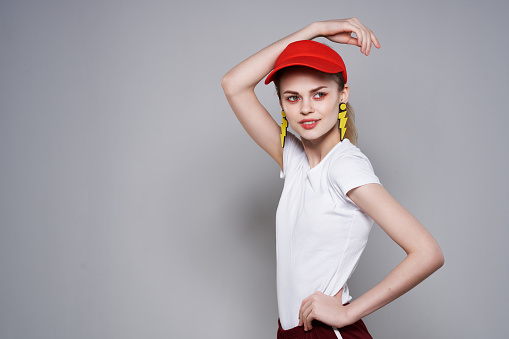 woman in red cap yellow earrings summer fashion glamor. High quality photo