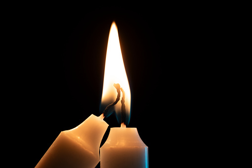 Burning candles on dark background